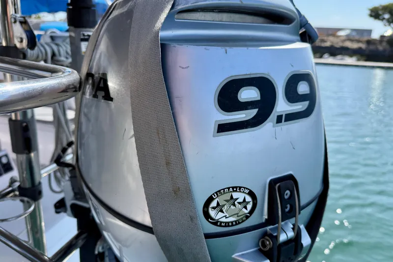 Nereid Yacht Photos Pics Outboard motor on Catalina 425 sailboat, 9.9 horsepower, ultra-low emission, docked by water.