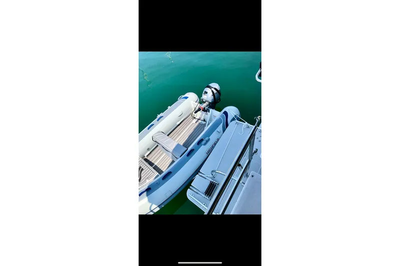Nereid Yacht Photos Pics Inflatable boat docked beside Catalina 425 yacht, 2020 model, on calm water.
