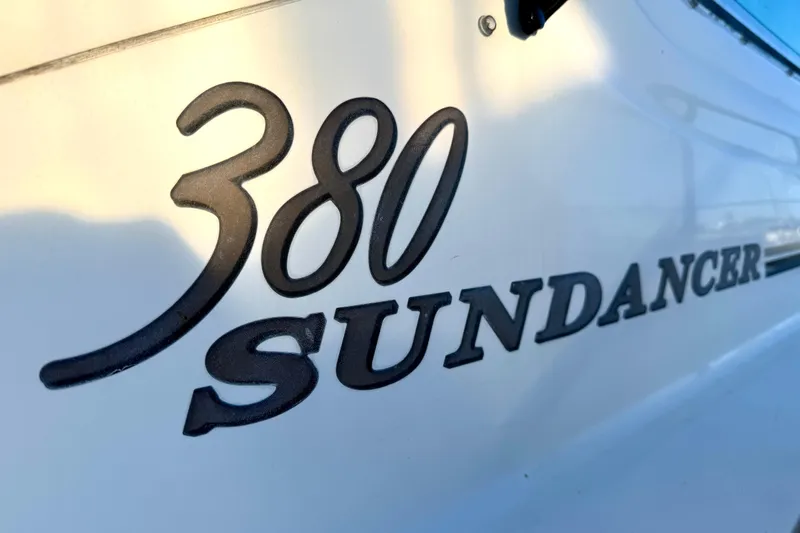 The Office Yacht Photos Pics Close-up of 2003 Sea Ray 380 Sundancer logo on boat hull.