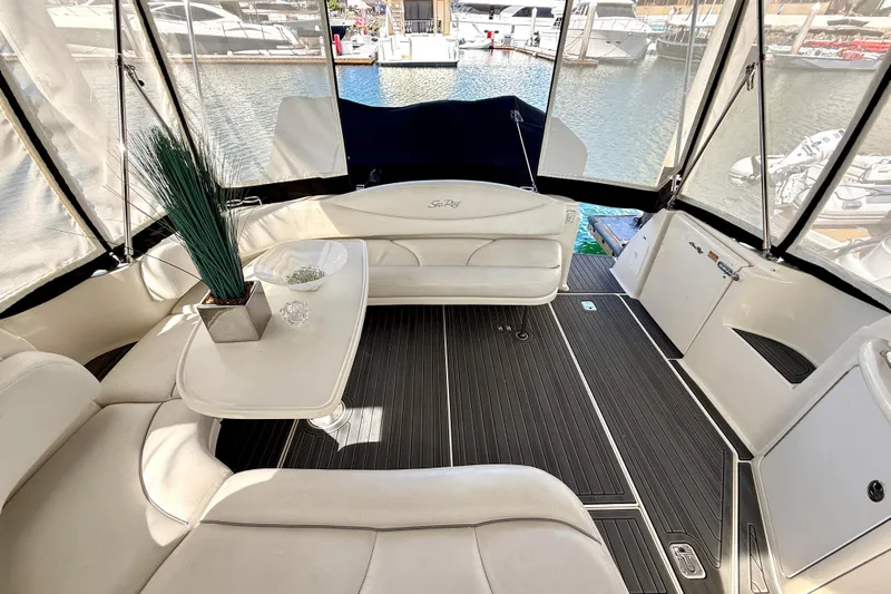 The Office Yacht Photos Pics Interior of 2003 Sea Ray 380 Sundancer yacht with elegant seating and table setup.