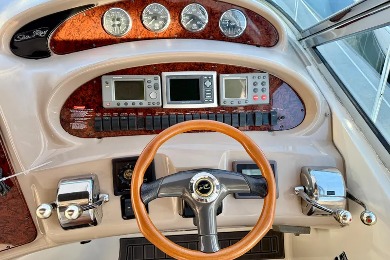 The Office Yacht Photos Pics 2003 Sea Ray 380 Sundancer helm with gauges, controls, and wooden steering wheel.