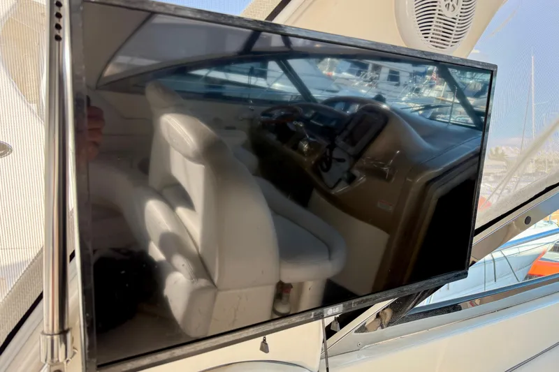 The Office Yacht Photos Pics 2003 Sea Ray 380 Sundancer interior with TV reflection and helm view.