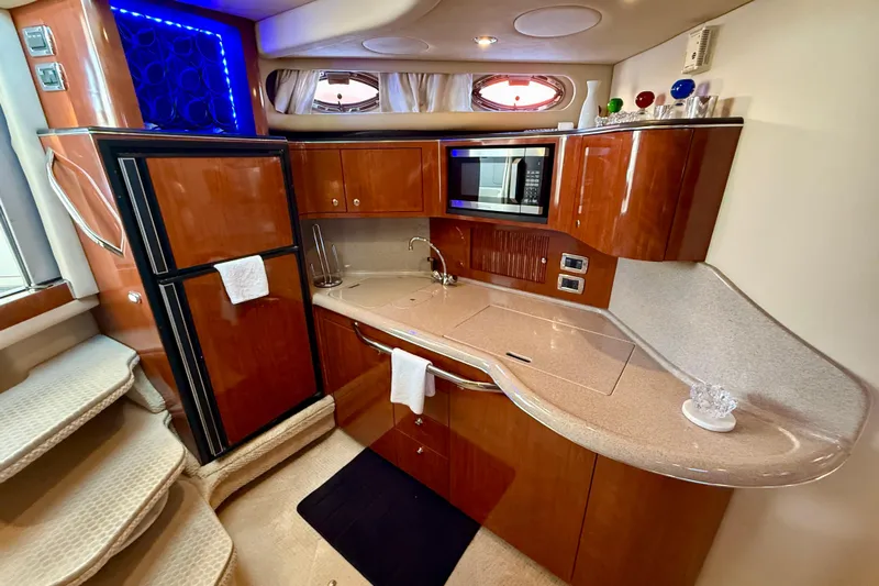 The Office Yacht Photos Pics Luxurious 2003 Sea Ray 380 Sundancer yacht kitchen with wood cabinetry and modern appliances.