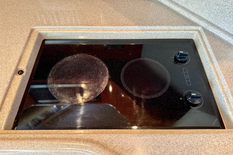 The Office Yacht Photos Pics Stovetop on 2003 Sea Ray 380 Sundancer yacht, featuring two burners and control knobs.