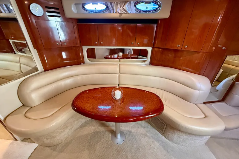 The Office Yacht Photos Pics Luxurious interior of 2003 Sea Ray 380 Sundancer with leather seating and wooden table.