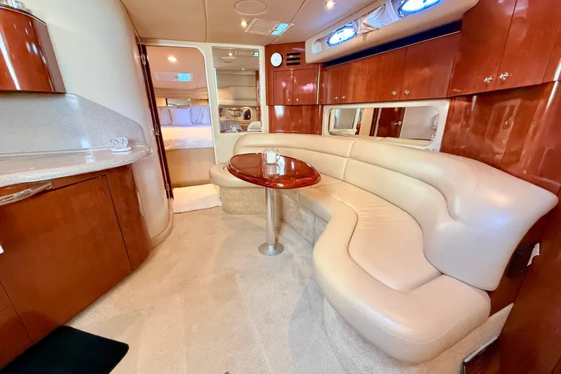 The Office Yacht Photos Pics Luxurious interior of 2003 Sea Ray 380 Sundancer yacht with elegant seating and wood finishes.