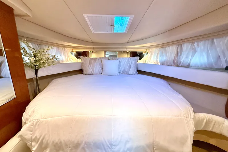 The Office Yacht Photos Pics Luxurious cabin interior of 2003 Sea Ray 380 Sundancer with plush bedding and elegant decor.