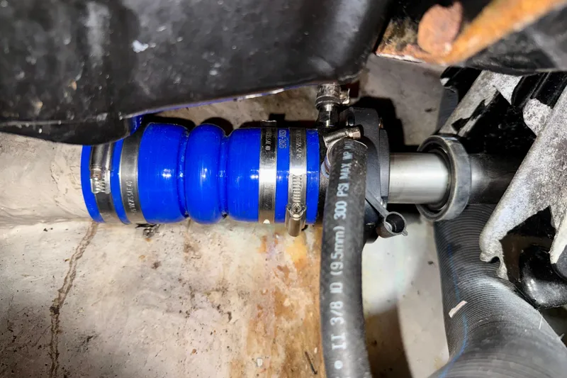 The Office Yacht Photos Pics Close-up of a 2003 Sea Ray 380 Sundancer engine component with blue hose and clamps.