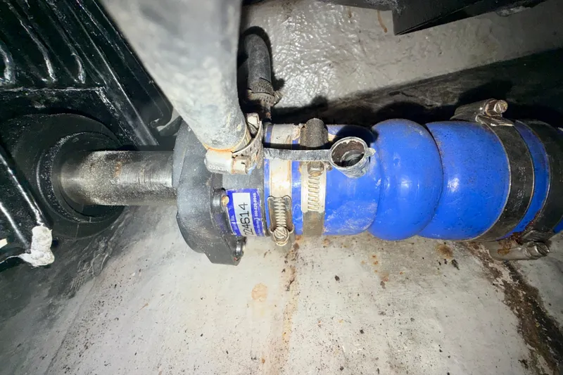 The Office Yacht Photos Pics Close-up of a 2003 Sea Ray 380 Sundancer engine component with blue hose and clamps.