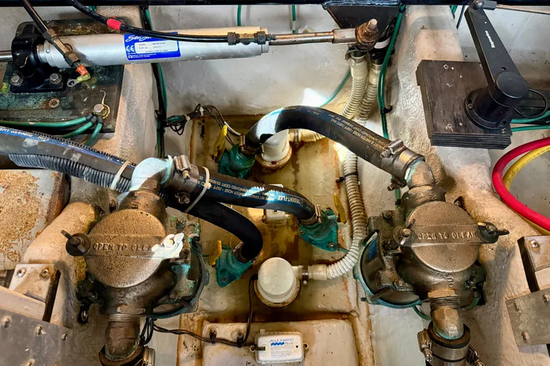 The Office Yacht Photos Pics Engine compartment of a 2003 Sea Ray 380 Sundancer, showcasing mechanical components and hoses.