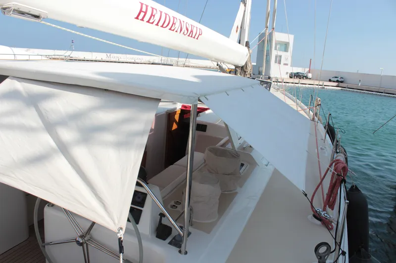 Heidenskip Yacht Photos Pics Custom 2005 Keel Cutter Rigged Sloop with sunshade, docked at marina.