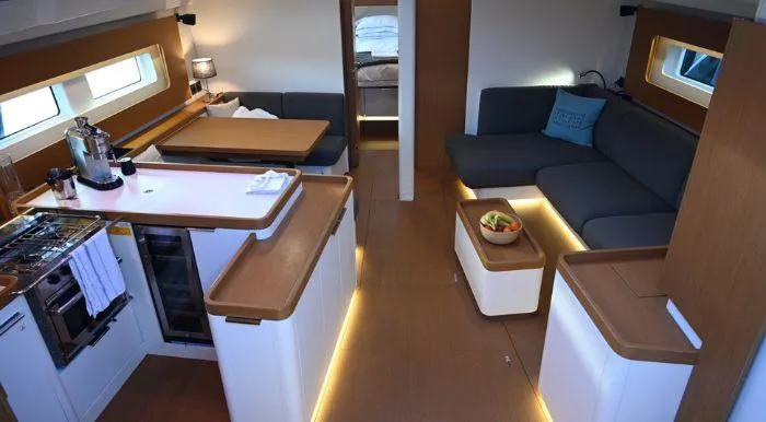 Yagiza Yacht Photos Pics Luxurious interior of 2020 Beneteau First 53 yacht with modern kitchen and seating area.