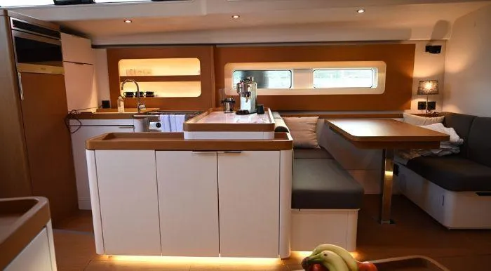 Yagiza Yacht Photos Pics Luxurious interior of 2020 Beneteau First 53 yacht with modern kitchen and seating area.