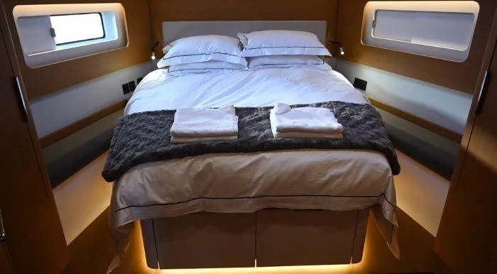 Yagiza Yacht Photos Pics Luxurious cabin interior of 2020 Beneteau First 53 yacht with cozy bedding.