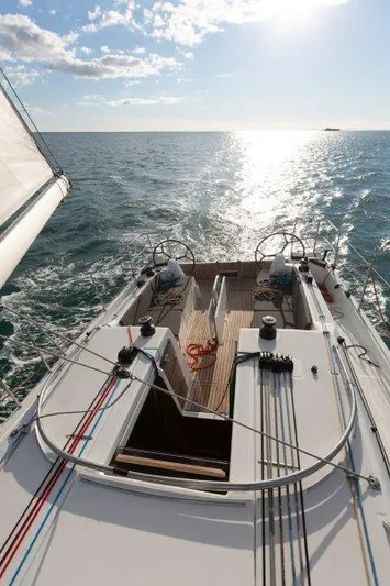 Pearl Yacht Photos Pics 2025 Jeanneau 380 sailboat on open sea, sunny day, dual steering wheels.