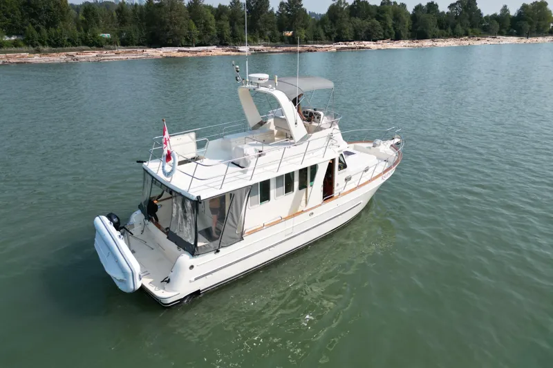 Raven Song Yacht Photos Pics 2011 North Pacific 38 Sedan yacht cruising on calm waters.