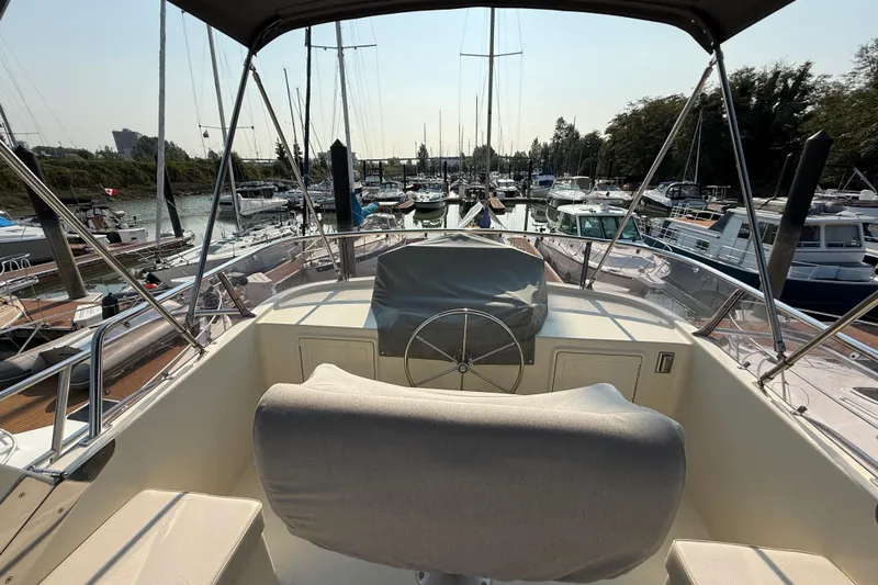 Raven Song Yacht Photos Pics Flybridge view of 2011 North Pacific 38 Sedan in a marina setting.