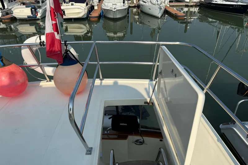 Raven Song Yacht Photos Pics 2011 North Pacific 38 Sedan yacht deck with marina view and Canadian flag.