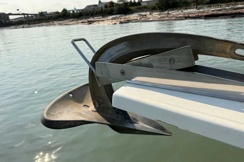 Raven Song Yacht Photos Pics Anchor detail on 2011 North Pacific 38 Sedan boat, docked on calm water.