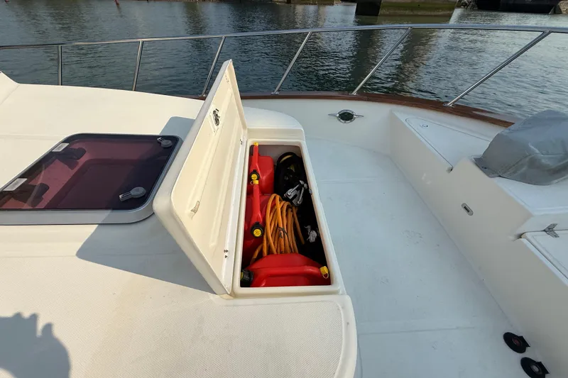 Raven Song Yacht Photos Pics 2011 North Pacific 38 Sedan boat deck with open storage compartment, revealing equipment.