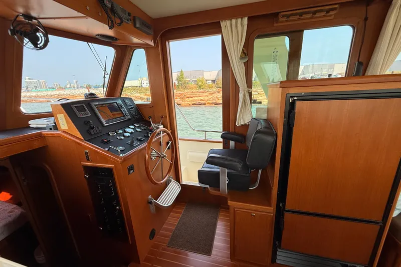 Raven Song Yacht Photos Pics Interior of 2011 North Pacific 38 Sedan boat with helm and navigation equipment.