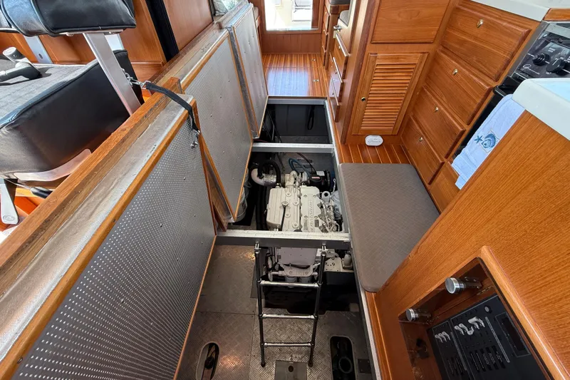 Raven Song Yacht Photos Pics Engine room of 2011 North Pacific 38 Sedan with open access panel and visible engine.