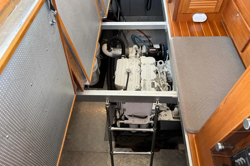 Raven Song Yacht Photos Pics Engine compartment of a 2011 North Pacific 38 Sedan boat, showcasing detailed machinery.