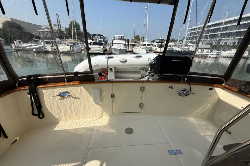 Raven Song Yacht Photos Pics 2011 North Pacific 38 Sedan boat interior with marina view, featuring a clean deck and equipment.