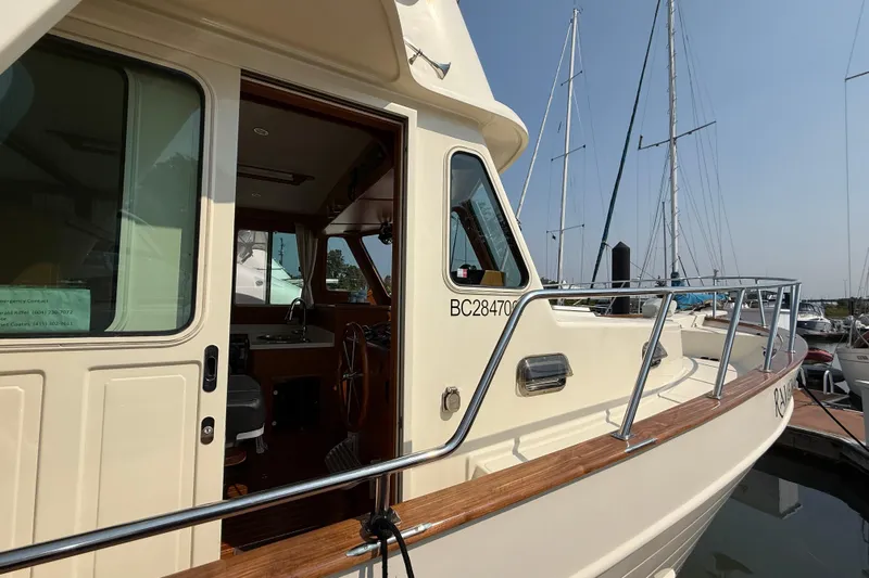 Raven Song Yacht Photos Pics 2011 North Pacific 38 Sedan yacht docked, showcasing open cabin and sleek design.