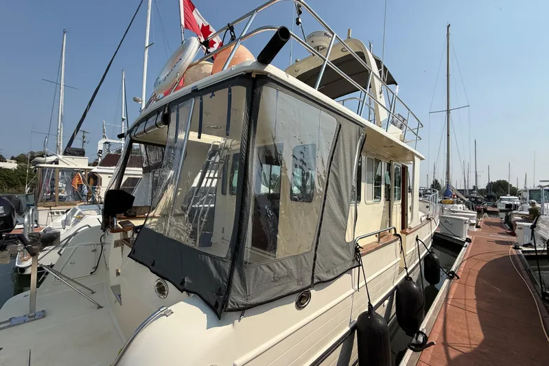 Raven Song Yacht Photos Pics 2011 North Pacific 38 Sedan yacht docked at marina with Canadian flag.