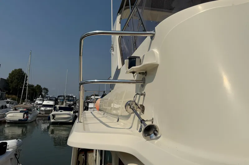 Raven Song Yacht Photos Pics 2011 North Pacific 38 Sedan yacht docked at marina, showcasing sleek design and railing.