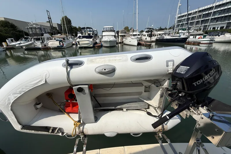 Raven Song Yacht Photos Pics Inflatable boat with Tohatsu motor docked at marina, North Pacific 38 Sedan, 2011.