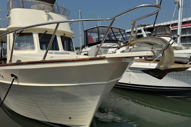 Raven Song Yacht Photos Pics 2011 North Pacific 38 Sedan boat docked at marina, front view.