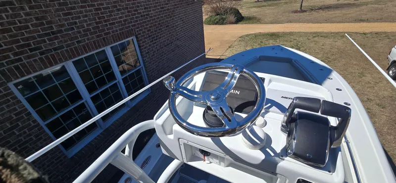  Yacht Photos Pics 2017 Yellowfin 36 boat helm with steering wheel and controls, parked near a brick building.