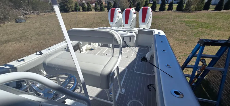  Yacht Photos Pics 2017 Yellowfin 36 boat interior with triple outboard engines, spacious seating, and modern controls.