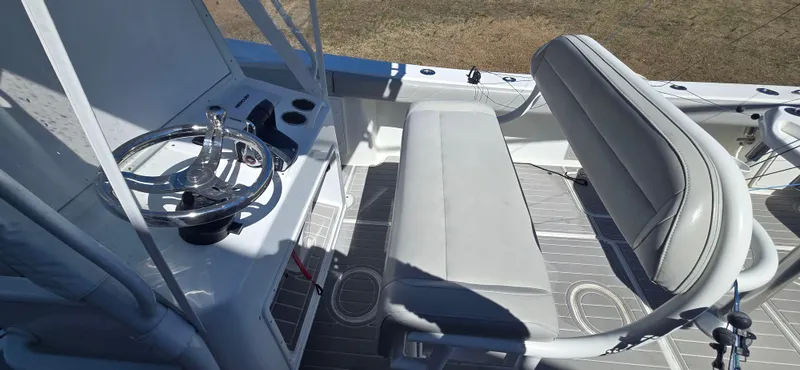  Yacht Photos Pics 2017 Yellowfin 36 boat interior with steering wheel and seating area.