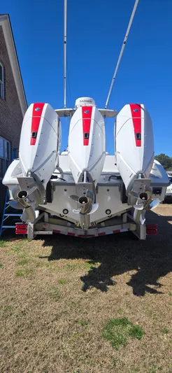  Yacht Photos Pics 2017 Yellowfin 36 boat with triple outboard engines, parked on grass.