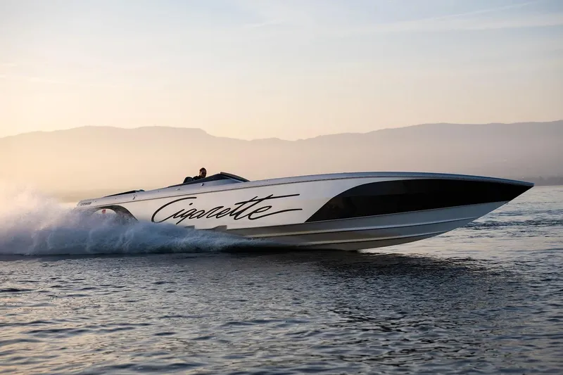  Yacht Photos Pics 2016 Cigarette 50' Marauder speedboat cruising on calm water at sunset.