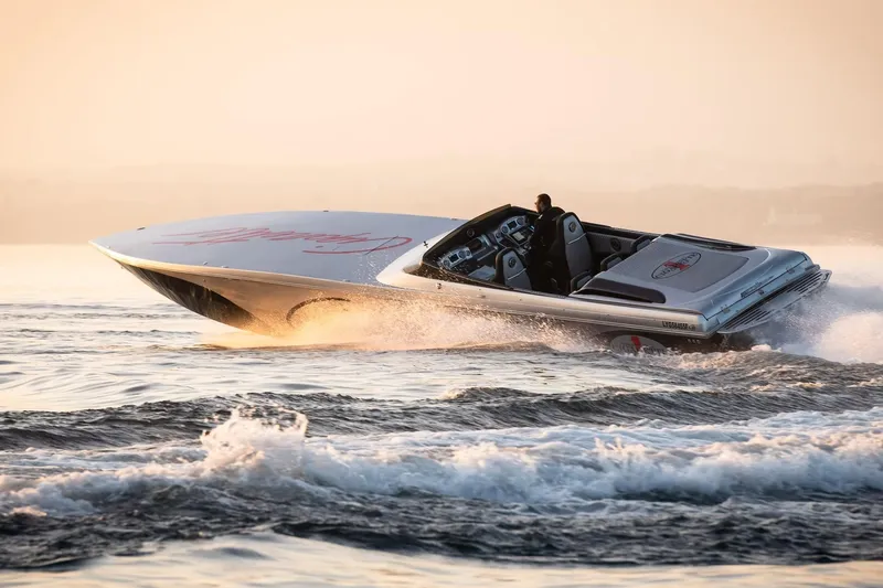  Yacht Photos Pics 2016 Cigarette 50' Marauder speedboat cruising on open water at sunset.