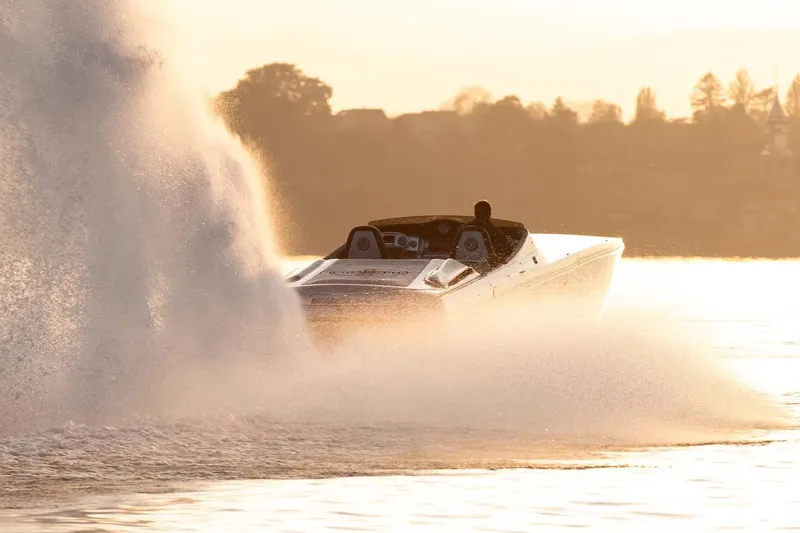  Yacht Photos Pics 2016 Cigarette 50' Marauder speedboat creating splash at sunset on water.