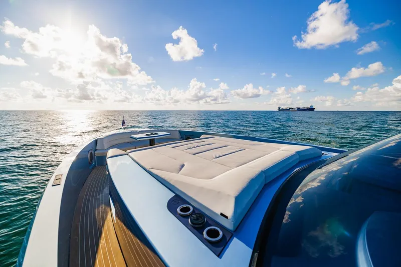 Impulsive Yacht Photos Pics Luxurious 2019 Vanquish Yachts VQ58 on open sea under clear blue sky.