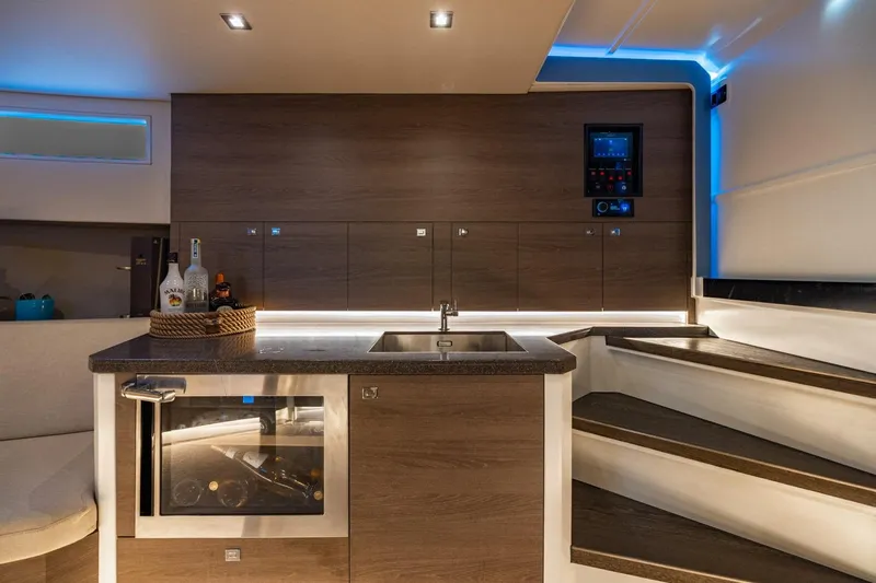 Impulsive Yacht Photos Pics Luxurious 2019 Vanquish Yachts VQ58 interior with modern kitchen and ambient lighting.