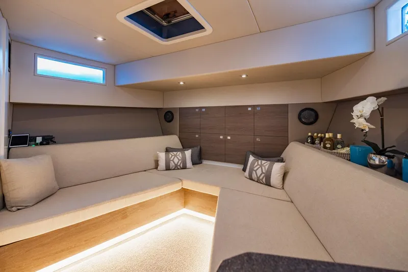 Impulsive Yacht Photos Pics Luxurious interior of 2019 Vanquish Yachts VQ58 with modern seating and elegant decor.