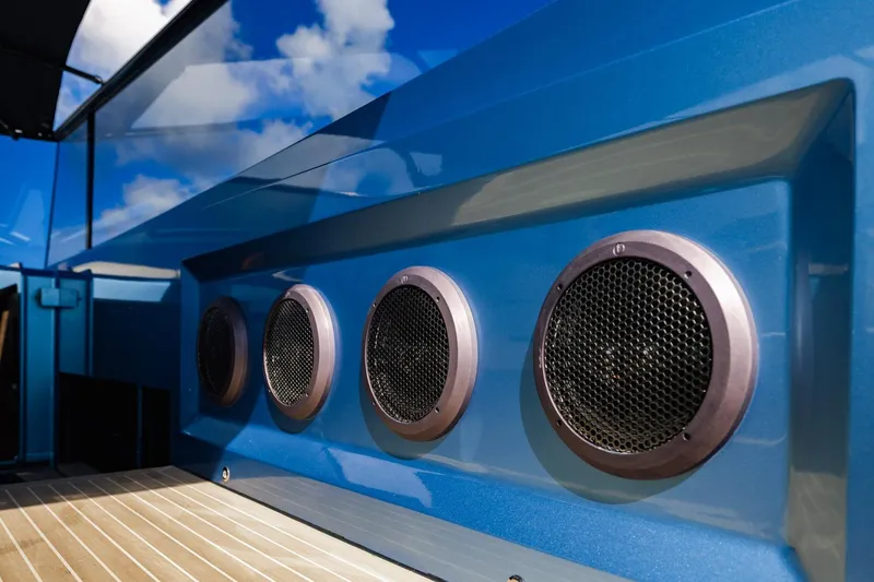 Impulsive Yacht Photos Pics Close-up of 2019 Vanquish Yachts VQ58 speakers on a sleek blue exterior.
