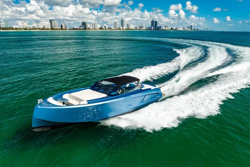 Impulsive Yacht Photos Pics 2019 Vanquish Yachts VQ58 cruising on blue ocean near city skyline.