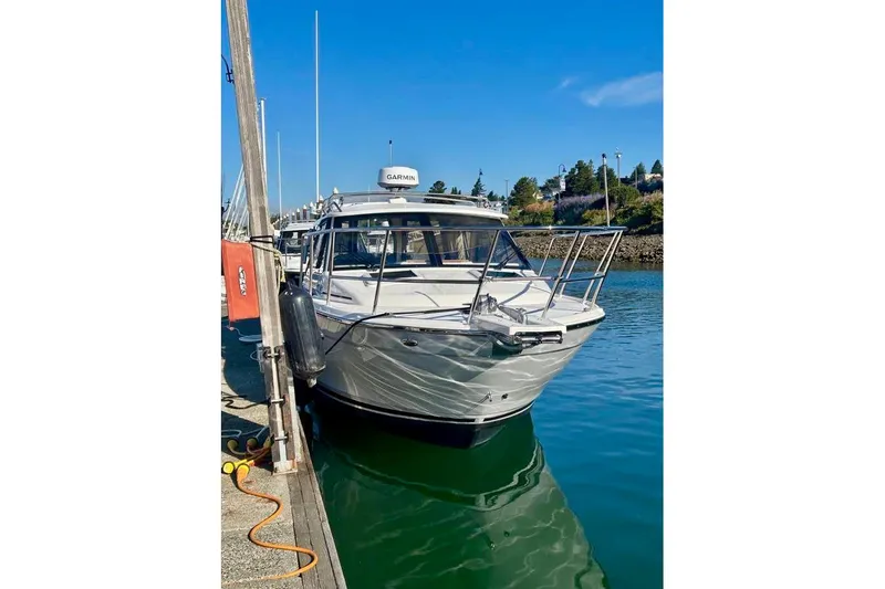  Yacht Photos Pics 2025 Cutwater C-248 Coupe docked in a marina under clear blue skies.
