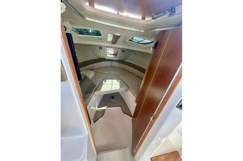 Yacht Photos Pics 2025 Cutwater C-248 Coupe cabin interior with cozy sleeping area and natural light.