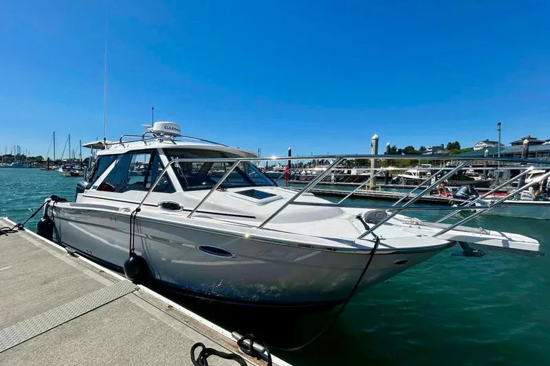  Yacht Photos Pics 2025 Cutwater C-248 Coupe docked at a marina under clear blue skies.