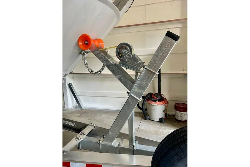  Yacht Photos Pics Trailer hitch mechanism for 2025 Cutwater C-248 Coupe boat in a garage setting.
