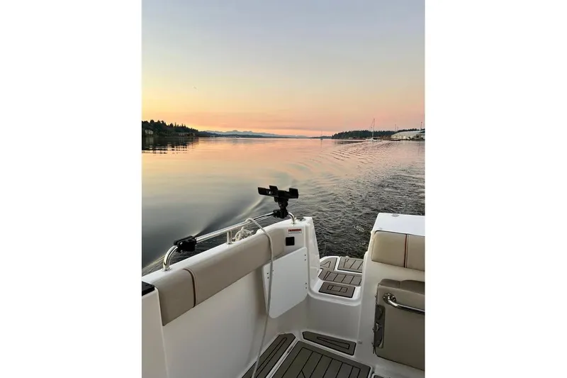  Yacht Photos Pics 2025 Cutwater C-248 Coupe cruising at sunset on a serene lake.